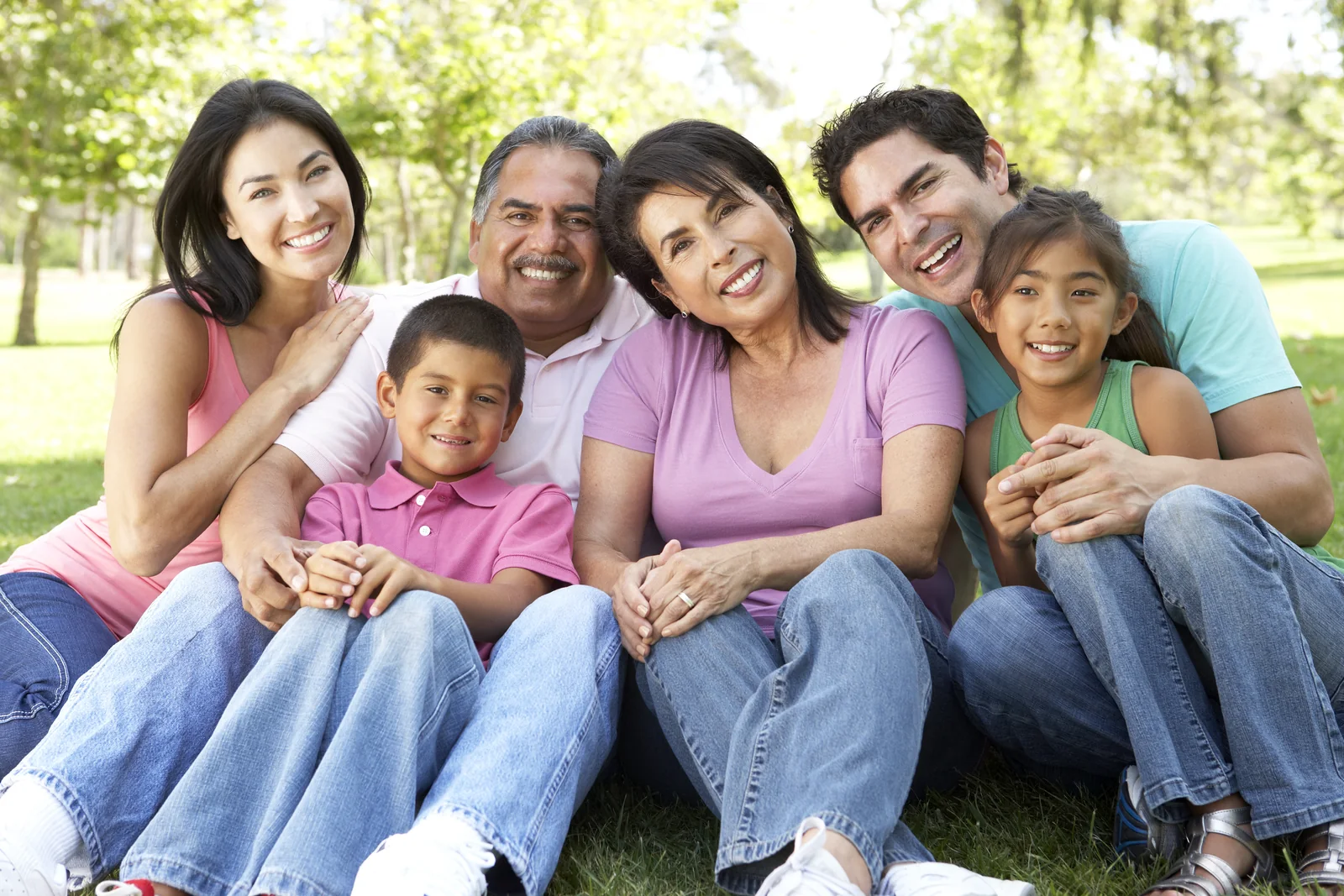 Smiling multigenerational Hispanic family together outdoors